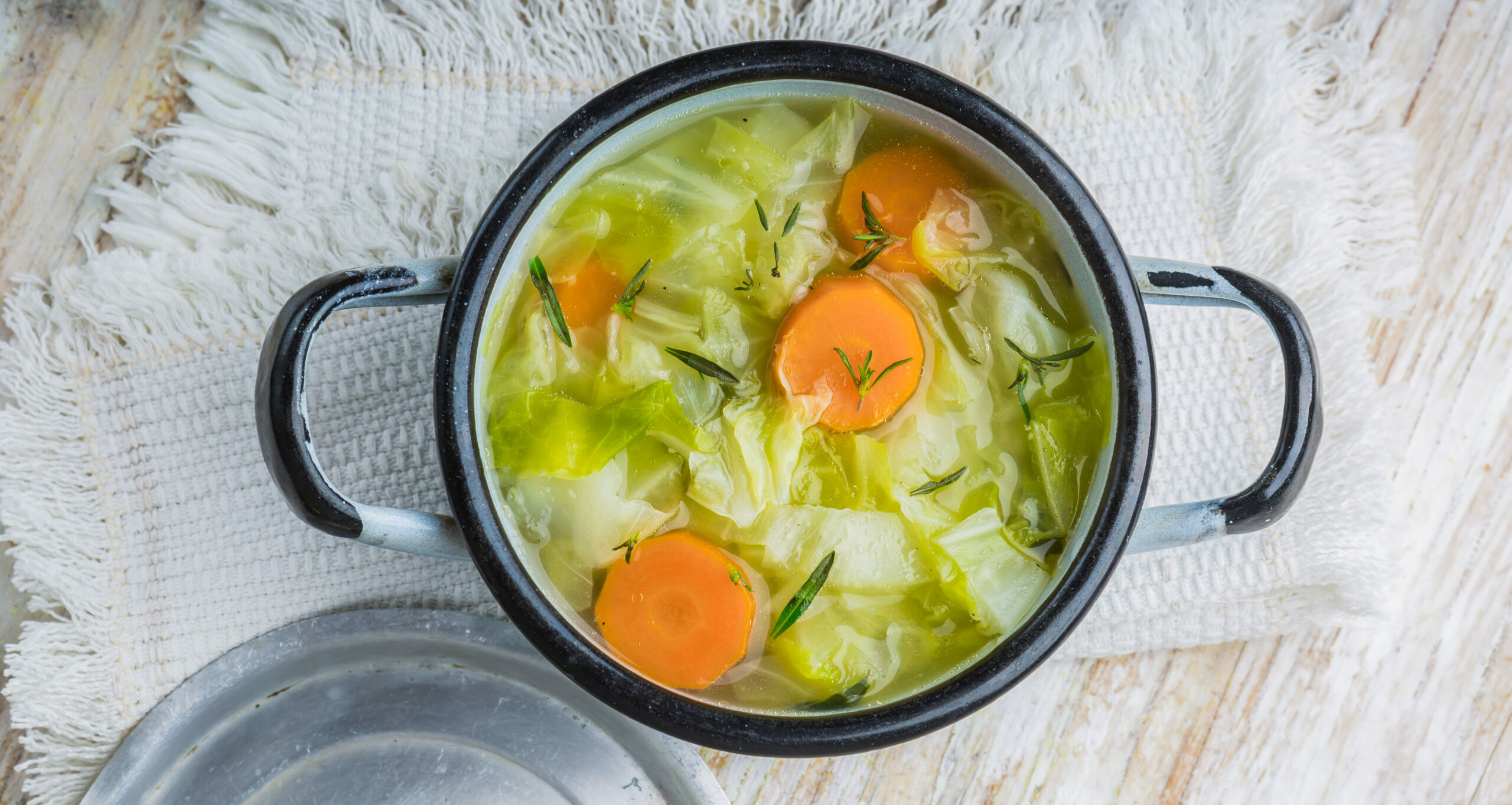 Fresh,Cabbage,Soup,In,A,Pot,On,White,Wooden,Table